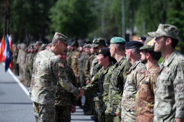 Army Gen. Daniel R. Hokanson, chief, National Guard Bureau, talks with multinational troops supporting a NATO mission, Adazi Military Base, Latvia, June 16, 2022.
