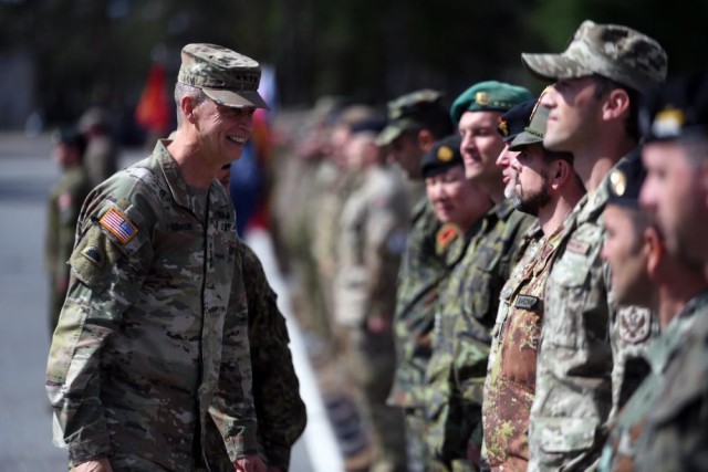 Army Gen. Daniel R. Hokanson, chief, National Guard Bureau, talks with multinational troops supporting a NATO mission, Adazi Military Base, Latvia, June 16, 2022.