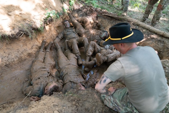 After low crawling through a muddy trench, Soldier in the Wisconsin Army National Guard’s 1st Squadron, 105th Cavalry work as a team to answer questions as they are quizzed on cavalry knowledge as part of a voluntary qualification course known...