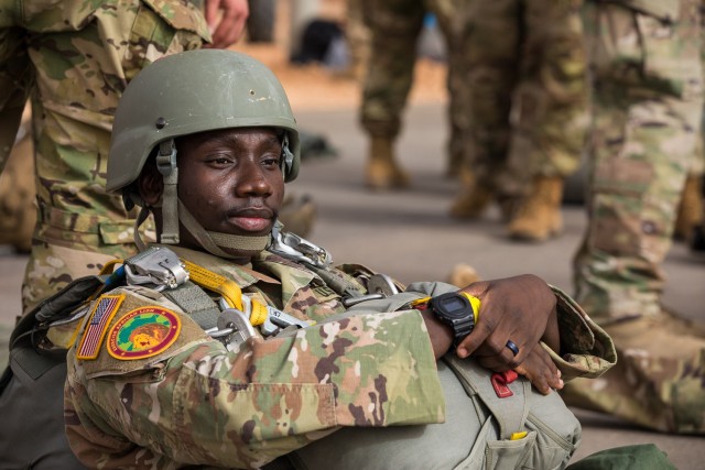 A U.S. Army Soldier assigned to the 19th Special Forces Group (Airborne), Utah Army National Guard, sits on the tarmac of an airport in Grier Labouihi, Morocco, waiting to board a Moroccan C-130 during an airborne operation during African Lion 22, June 19, 2022. African Lion 22 is U.S. Africa Command's largest, premier, joint, combined annual exercise hosted by Morocco, Ghana, Senegal, and Tunisia, June 6 - 30. More than 7,500 participants from 28 nations and NATO train together with a focus on enhancing readiness for U.S. and partner-nation forces. AL22 is a joint all-domain, multi-component, and multinational exercise, employing a full array of mission capabilities with the goal to strengthen interoperability among participants and set the theater for strategic access. (U.S. Army National Guard photo by Spc. Mackenzie Willden)