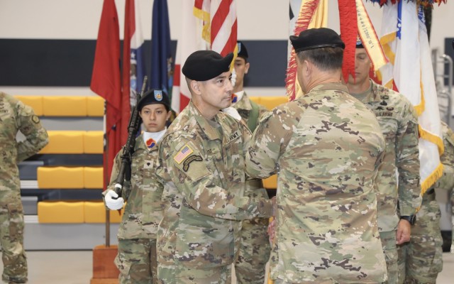 Brig. Gen. Frederick L. Crist, commanding general, 19th Expeditionary Sustainment Command, accepts the command colors from Lt. Gen. Willard M. Burleson III, commanding general, Eighth Army, during a change of command ceremony on Camp Walker, Republic of Korea. Brig. Gen. Steven L. Allen relinquished command during the ceremony, which also featured Eighth Army&#39;s Combined Forces Band.