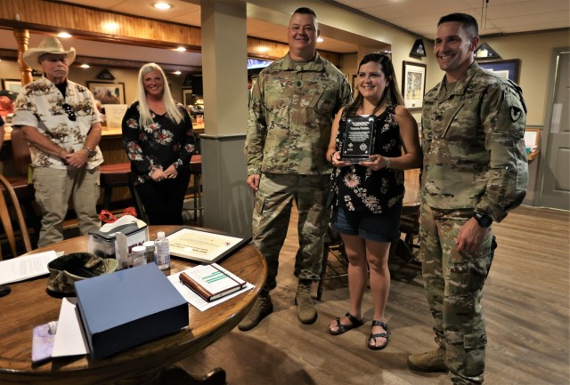Fort Knox American Red Cross chapter 2022 Volunteer of the Year recipient Suzie Rendon holds the plaque presented to her June 29 by Fort Knox Garrison Commander Col. Lance O’Bryan and Garrison Command Sgt. Maj. William Fogle.