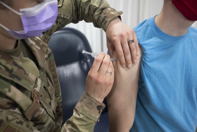 Air Force Tech. Sgt. Elizabeth Nardo, 158th Fighter Wing, Vermont Air National Guard, injects James Bordeaux with a dose of COVID-19 vaccine at Camp Johnson, Vermont, March 18, 2021. The Vermont National Guard concludes its COVID missions July 1, 2022. (U.S. Army National Guard photo by Marcus Tracy)