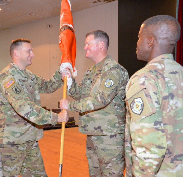 Col. John Popiak, Army Cyber Protection Brigade commander (left), passes the guidon of the 60th Signal Battalion (Offensive Cyber Operations) to incoming battalion commander Lt. Col. Charles Walsh (right), during the battalion’s change of...