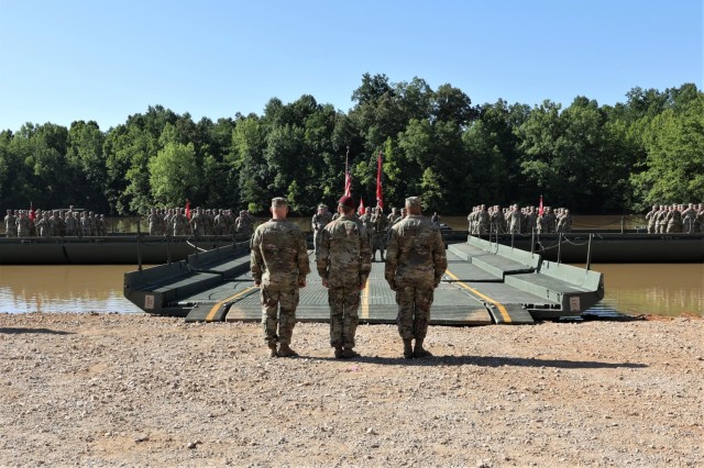Change of command ceremony host Col. Daniel Herlihy, commander of 20th Engineer Brigade, prepares to board a floating bridge on Tobacco Leaf Lake with outgoing 19th Engineer Battalion Commander Lt. Col. Christopher Beal and incoming commander Lt. Col. Todd Bradford to perform the passing of the unit’s colors June 30, 2022.