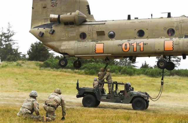 National Guard Soldiers from the Pacific Northwest trained in sling-load maneuvers in June at Camp Rilea in Oregon. The helicopter is from Detachment 1, Company B, 1st Battalion, 168th Aviation, Oregon Army National Guard. 
