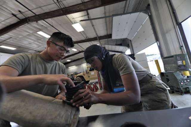 Mechanics from military police units turn wrenches