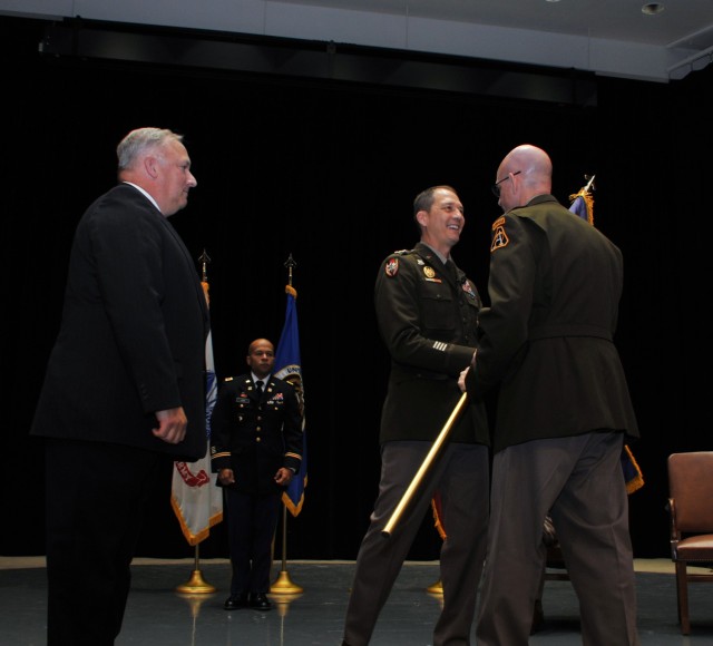 Peterson accepts the PEO CS&CSS colors from Lt. Gen. Robert L. Marion, ASA(ALT) principal military deputy, in the June 30 ceremony held at the historic Detroit Arsenal.  Andrew “Andy” DiMarco (left,) deputy PEO CS&CSS, served as the acting PEO prior to Peterson’s assignment here.