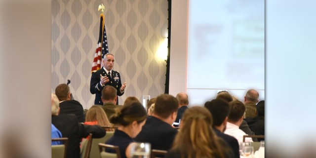 Col. Mark Taylor, project manager for Defensive Cyber Operations at PEO EIS, speaks at the AFCEA Belvoir Luncheon on June 22, 2022.