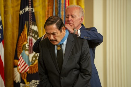 Former Spc. 5 Dennis Fujii, receives the Medal of Honor from the president Joe Biden in the East Room of the White House on July 5, 2022. Fujii distinguished himself by conspicuous gallantry and intrepidity beyond the call of duty while serving as crew chief aboard a helicopter ambulance during rescue operations in Laos, Republic of Vietnam in February 1971. On March 20, 1971, Fujii was awarded the Distinguished Service Cross for his actions. On Dec. 9, 2020, the Secretary of the Army recommended upgrade of his award to the Medal of Honor. (U.S. Army photo by Sgt. Henry Villarama)