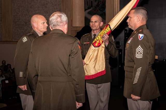 IMCOM Commanding General Lt. Gen. Omar Jones (center) accepts the command guidon during his assumption of command ceremony July 5 at Joint Base San Antonio-Fort Sam Houston. AMC Commanding General Gen. Ed Daly (left), Lt. Gen. Douglas Gabram (back to camera) and IMCOM Command Sergeant Major Joe Ulloth also participated in the ceremony.