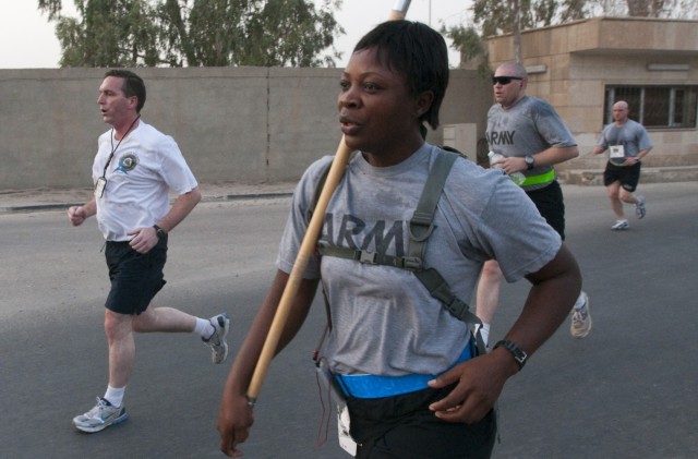 Then Staff Sgt. Asaah carries the  guidon for B Company III Corps Special Troops Battalion