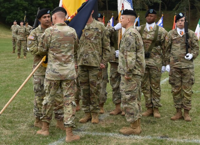 Maj. Gen. Michael D. Wickman, U.S. Army Europe and Africa deputy commanding general for Army National Guard, passes the U.S. Army NATO Brigade colors to Col. Troy V. Alexander during a change of command ceremony July 7 at Sembach Kaserne.