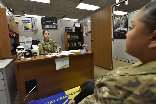 Staff Sgt. Stephanie Rojas, 3rd Chemical Brigade career counselor, speaks with a Soldier on Wednesday about reenlisting. Career counselors assist the Army in retaining the right talent in the right place at the right time. 