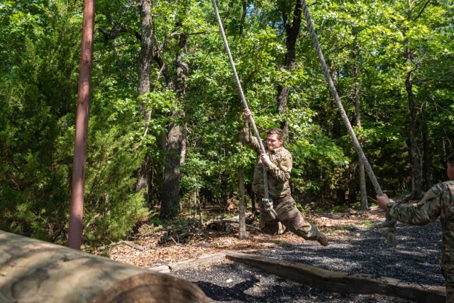 Sgt. Preston Kinnett, 763rd Ordnance Company (Explosive Ordnance Disposal), swings across station 16 – called “The Swing, Stop, Jump” – of Fort Leonard Wood’s Confidence Course July 1 on Training Area 97. Kinnett is one of two EOD Soldiers from the 763rd here training for Army Air Assault School.