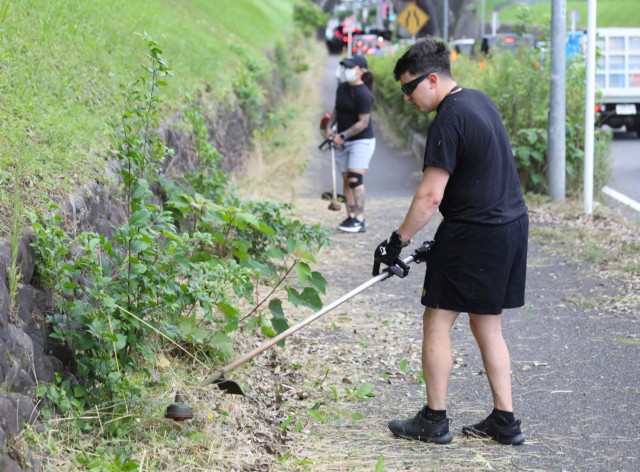 Staff Sgt. Hisham Bulling, assigned to the 38th Air Defense Artillery Brigade, participates in a beautification project outside the main gate of Camp Zama, Japan, July 8, 2022. More than 20 U.S. Soldiers and Japanese counterparts conducted the cleanup that also aimed to strengthen their partnership.