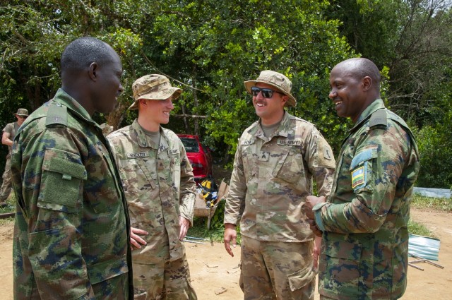 A pair of Soldiers from the Nebraska Army National Guard's Wahoo-base 623rd Engineer Company share jokes with pair of Rwanda Defense Force Soldiers during a break while constructing a guard tower during an exercise in Rwanda. The Soldiers were participating in a exchange effort between the Nebraska Army National Guard and the Rwanda Defense Force as part of the National Guard's State Partnership Program. (Nebraska Air National Guard photo by Lt. Col. Kevin Hynes)