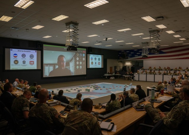 Members of the audience listen to speaker who joined via Microsoft Teams during the 2022 Hurricane Rehearsal of Concept drill, at Joint Base San Antonio-Fort Sam Houston, Texas, April 25, 2022. The primary purpose of the rehearsal was to prepare participants to support the Federal Emergency Management Agency, the lead federal agency for hurricane response, during the 2022 Atlantic Hurricane Season, which begins June 1. In addition to response and recovery-focused discussions participants also talked about national resiliency in support of the National Response Framework. (U.S. Army photo by Sgt. Ashlind House /U.S. Army North)