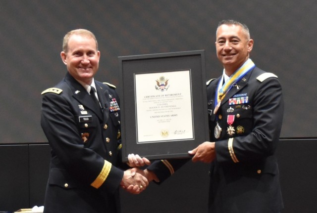 Col. Roger Kuykendall, right, accepts his certificate of retirement from Lt. Gen. Thomas Todd, deputy commander or acquisition and systems and chief innovation officer at Army Futures Command. Prior to his retirement, Kuykendall relinquished...