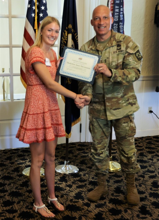 Commanding General of the U.S. Army Cadet Command and Fort Knox Maj. Gen. Johnny Davis presents each of the four student recipients with certificates representing scholarships from the Armed Forces Communications and Electronics Association at the Saber and Quill July 11, 2022.