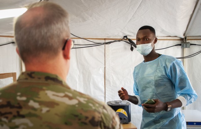 Maj. Gen. Daryl Bohac, Nebraska National Guard adjutant general, listens as a doctor from the Rwanda Defense Force's Medical Corps explains how Rwandan medical providers conduct triage operations at a United Nation's Level 2 Hospital during a medical/engineering exercise at Gako, Rwanda, March 17.  The Nebraska National Guard and the Rwanda Defense Force were training together during the exercise that was conducted as part of the National Guard's State Partnership Program. (Nebraska Air National Guard photo by Lt. Col. Kevin Hynes)