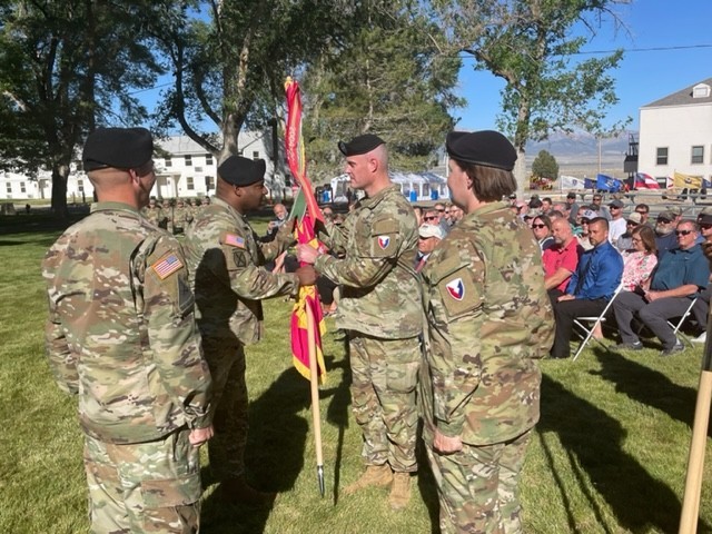Col. Landis C. Maddox, commander, Joint Munitions Command, passing the TEAD flag to Col. Eric B. Dennis, incoming commander.  Col. Steven M. Dowgielewicz, far left, and CSM Petra Casarez, far right, observe the passing of the TEAD flag during the TEAD Change of Command Ceremony.