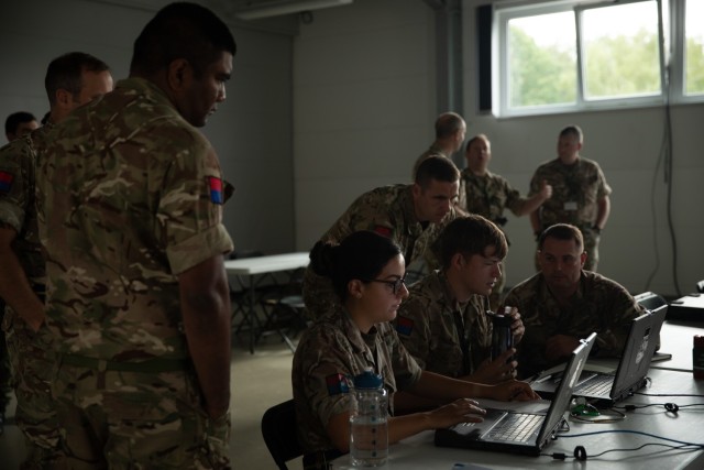 British soldiers work to sync their operating systems during an Artillery Systems Cooperation Activities training at Grafenwoehr Training Area, Germany, July 10, 2022. Dynamic Front 2022, led by 56th Artillery Command and U.S. Army Europe and Africa directed, is the premiere U.S. led NATO Allied and Partner integrated fires exercise in the European Theater focusing on fire interoperability and increasing readiness, lethality and interoperability across the human, procedural and technical domains. (U.S. Army photo by Spc. Dominique' Crittenden, 5th Mobile Public Affairs Detachment)