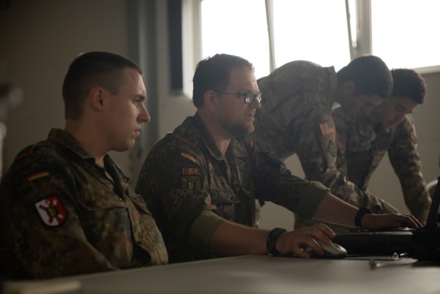 German and U.S. Army Soldiers work to sync their operating systems during an Artillery Systems Cooperation Activities training at Grafenwoehr Training Area, Germany, July 10, 2022. Dynamic Front 2022, led by 56th Artillery Command and U.S. Army Europe and Africa directed, is the premiere U.S. led NATO Allied and Partner integrated fires exercise in the European Theater focusing on fire interoperability and increasing readiness, lethality and interoperability across the human, procedural and technical domains. (U.S. Army photo by Spc. Dominique' Crittenden, 5th Mobile Public Affairs Detachment)