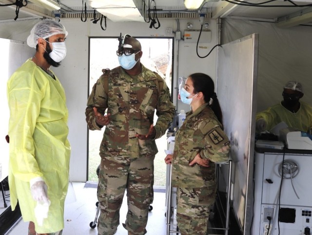 From left to right, Maj. W.A. Mustafa, South African Military Health Service dentist,  speaks with counterparts from the Army Reserves and the New York Army National Guard, Dentist Maj. Dwayne Bodie and dental technician Staff Sgt. Christine Iracion, July 13, 2022, outside Richards Bay, South Africa. The 2022 exercise of Shared Accord is the fourth, with previous iterations in 2011, 2013, and 2017. (Courtesy photo)
