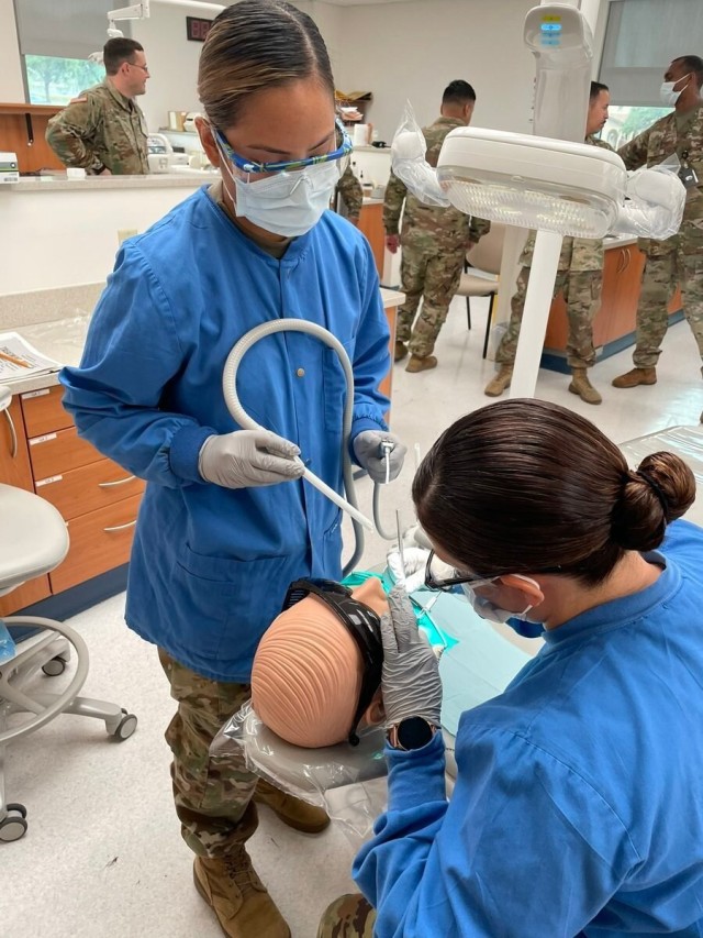 Dental students practice their skills while treating soldiers, dependents and retirees