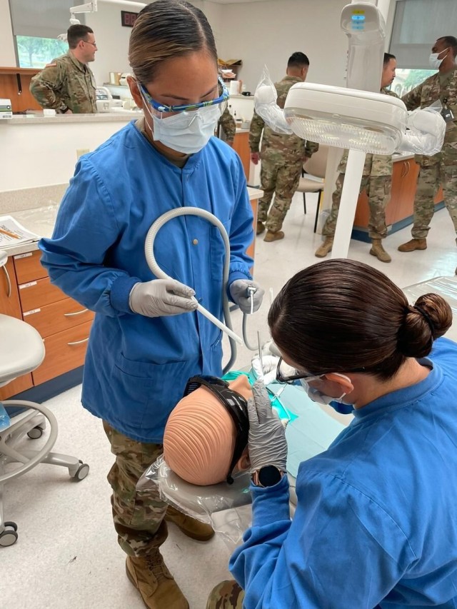 Dental students practice their skills while treating Soldiers, dependents, and retirees