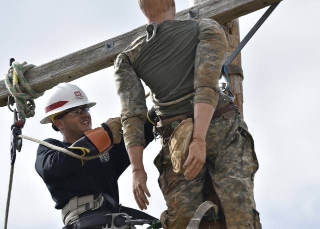 Pfc. Shawn Littleton competes in what’s called the hurt-man rescue event during the U.S. Army Prime Power School Lineman’s Rodeo Tuesday behind the USAPPS building. 