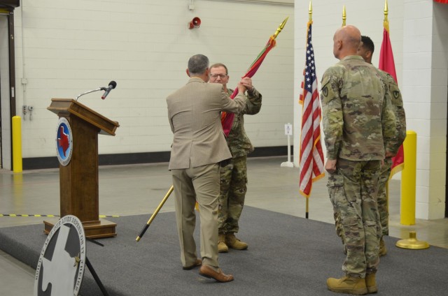 Col. Jonathan W. Meisel, new commander for Red River Army Depot, receives the depot flag from Brian Butler, deputy to the commanding general, U.S. Army Tank-automotive and Armaments Command.