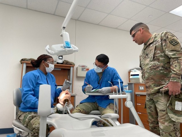 Dental students practice their skills while treating Soldiers, dependents, and retirees