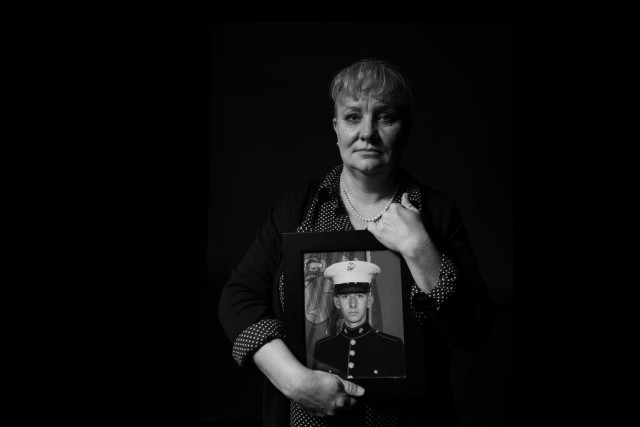 Virginia Cooper, U.S. Army Central's Soldier and Family Readiness Program manager, holds a photo of her son, Joshua Jaymes Wood, who committed suicide Nov. 7, 2021. (U.S. Army photo by Staff Sgt. Leo Jenkins)