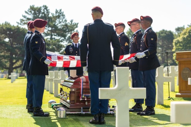 Soldiers from Battery A, 4th Battalion, 319th Airborne Field Artillery Regiment, 173rd Infantry Brigade Combat Team (Airborne) perform honor guard duties July 9 at Normandy American Cemetery for the internment of U.S. Army Air Forces 2nd Lt. William J. McGowan who was laid to rest nearly 80 years after he was killed during operations in France during WWII. The IMCOM-Europe Casualty Assistance Team worked with the American Battle Monuments Commission and units to coordinate the ceremony.
