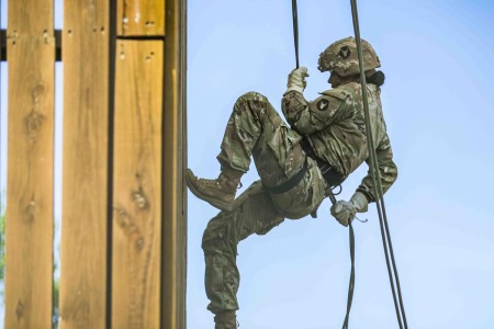 Army Spc. Lorena Martinez rappels down a tower during training at Camp Dodge in Johnston, Iowa, June 8, 2022.