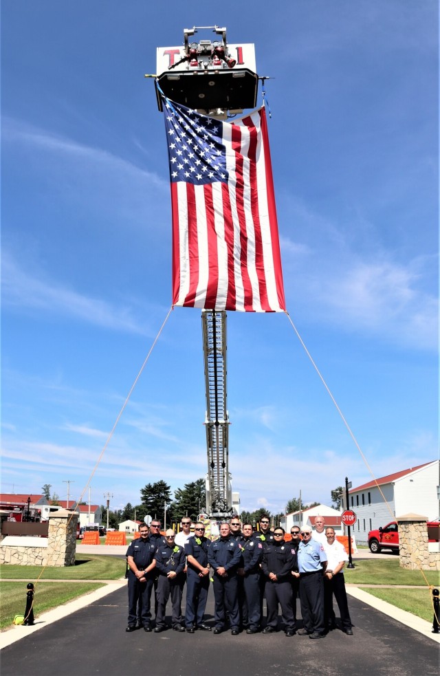 Firefighters and the American flag for Fort McCoy Garrison Change of Command ceremony