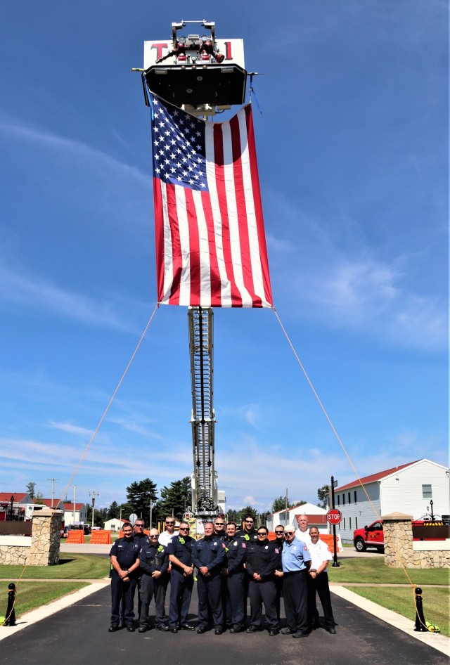 Firefighters and the American flag for Fort McCoy Garrison Change of Command ceremony