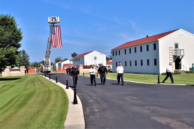 Firefighters and the American flag for Fort McCoy Garrison Change of Command ceremony
