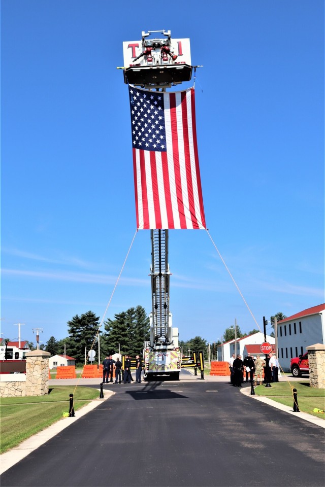 Firefighters and the American flag for Fort McCoy Garrison Change of Command ceremony
