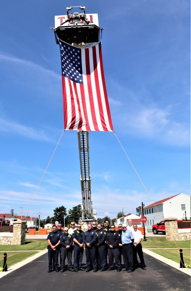 Firefighters and the American flag for Fort McCoy Garrison Change of Command ceremony