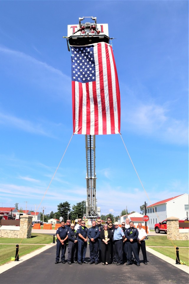 Firefighters and the American flag for Fort McCoy Garrison Change of Command ceremony