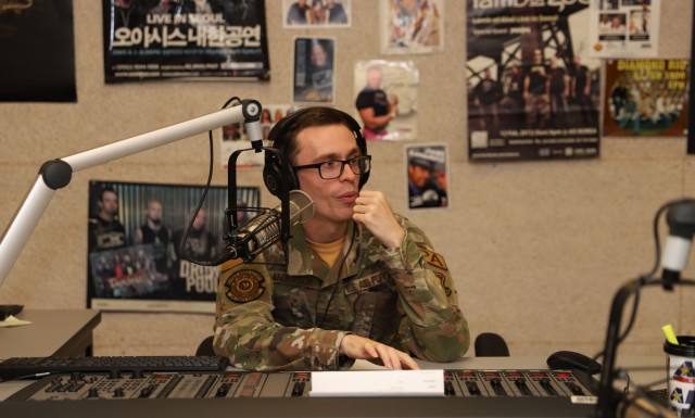 U.S. Airman hosts a midday radio show at the American Forces Network Station, Camp Humphreys, South Korea, July 20, 2022. The on-air interview discussed the Cadet Troop Leader Training program. (U.S. Army photo by Sgt. Evan Cooper)