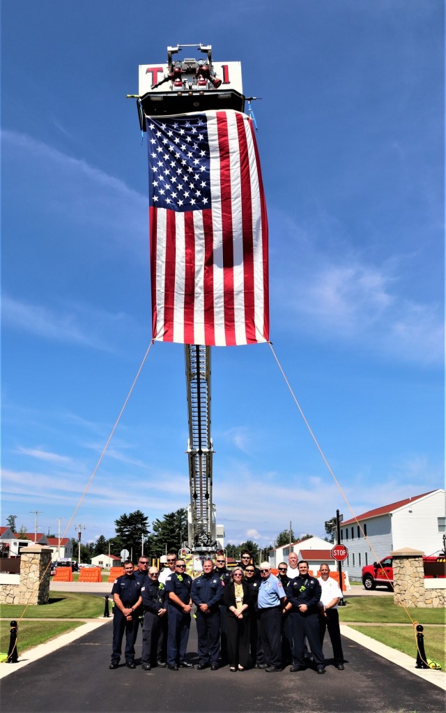 Firefighters and the American flag for Fort McCoy Garrison Change of Command ceremony