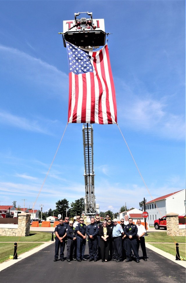 Firefighters and the American flag for Fort McCoy Garrison Change of Command ceremony