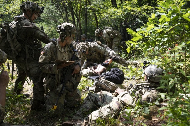 Massachusetts Army National Guard Soldiers assigned to Charlie Company, 1st Battalion, 181st Infantry Regiment, 44th Infantry Brigade Combat Team, perform combat life-saver tasks during a situational training exercise July 19, 2022, at the 44th IBCT’s eXportable Combat Training Capability exercise at Fort Drum, New York. More than 2,500 Soldiers participated in the training event, which enables brigade combat teams to achieve the trained platoon readiness to deploy, fight and win. (U.S. Army National Guard photo by Sgt. Bruce Daddis)