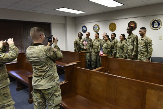 Maj. Gen. James Bonner, Maneuver Support Center of Excellence and Fort Leonard Wood commanding general (sixth from right), poses for a photo with some of Fort Leonard Wood’s newest U.S. citizens and their coworkers after a naturalization ceremony Wednesday at the Office of the Staff Judge Advocate courtroom – held in conjunction with the U.S. Citizenship and Immigration Services and the U.S. Courts, Western District of Missouri. 