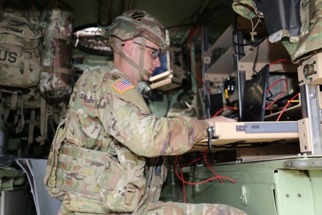 A Soldier using a laptop during the Armored Formation On-The-Move Network Pilot in Fort Stewart.