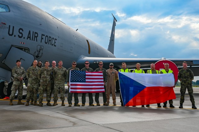 Air crew, maintainers and logistics Airmen with the 155th Air Refueling Wing, Nebraska Air National Guard, and Czech Air Force maintainers hold their countries flags during exercise Ample Strike 2021, Sept. 16, 2021, at Pardubice Airport, Czech Republic. (U.S. Air National Guard photo by Airman 1st Class Alexander D. Schriner)